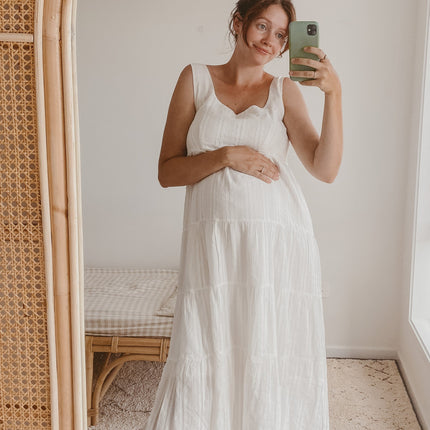 White Liza Midi Dress | Cotton Fabric | Tiered Skirt | Subtle Floral Pattern | Square Neckline | Thick Straps | Relaxed Fit | Mid-Length | Perfect for Summer and Maternity | Versatile and Comfortable